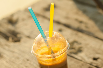 Wall Mural - Fresh juice in a plastic cup with two straws