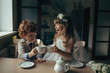 boy and girl having tea party in cafe