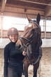 © XtravaganT - Horse nuzzling a smiling attractive young woman