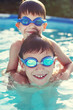© sakkmesterke - Happy little brothers in goggles swim