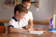 © sakkmesterke - Happy little boy studying at home with brother