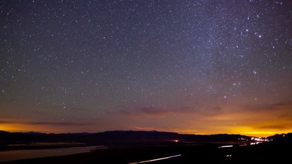 Wall Mural - Time lapse of a road going the desert with the night sky moving above.