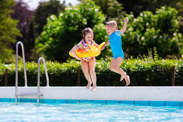 Kids jumping into swimming pool