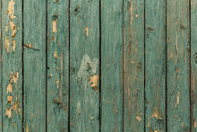 Old Wooden Plank Texture On A Door Or Wall Cladding With Peeling Weathered Green Paint Flaking Off From The Surface. Background