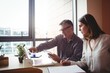 © Wavebreak Media - Man discussing with colleague over laptop