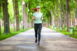 © Dmytro Panchenko - Full length portrait of a female runner running in the park.