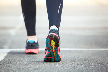 Close up of running shoes on road.