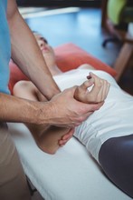 Physiotherapist Massaging Hand Of A Female Patient