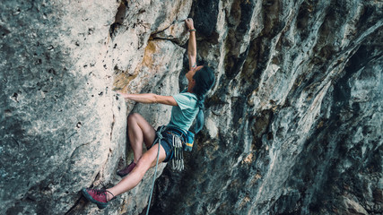 Woman with outfit climbing the rock