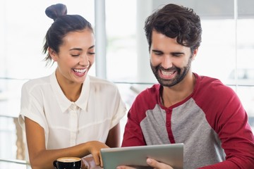 Wall Mural - Couple using digital tablet in cafe