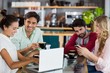 © WavebreakMediaMicro - Group of friends using mobile phone and laptop
