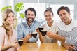 © WavebreakmediaMicro - Group of happy friends holding cup of coffee