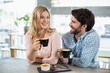 © WavebreakmediaMicro - Happy couple having cup of coffee