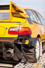 Wall Mural - Rearlights of yellow sport car with black diffuser