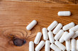 Creatine tablets on a wooden table