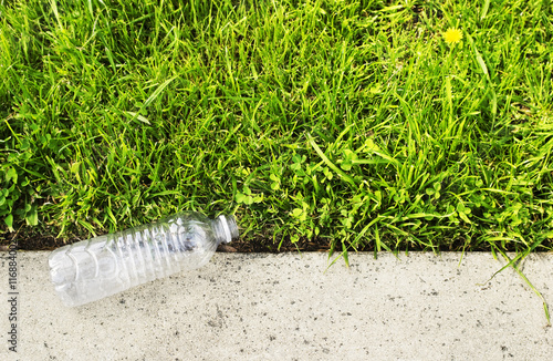 Fotografie, Obraz Recycle concept. Plastic bottle on green grass
