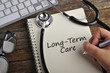 © tuan_azizi - Women Hand Write 'LONG-TERM CARE' On Note Book