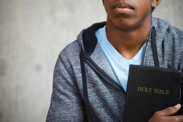 Young teen holding a Bible.