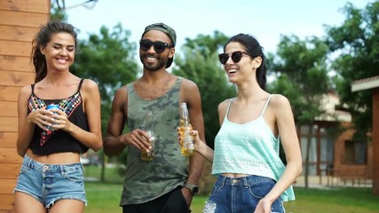 Sticker - Group of young beautiful happy teenagers walking and drinking beer at the picnic area