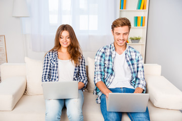 Sticker - Happy young man and woman working on two laptops