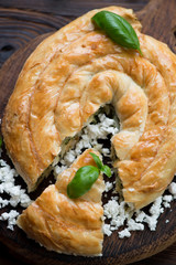 Wall Mural - Close-up of sliced burek pie with cheese and spinach, above view