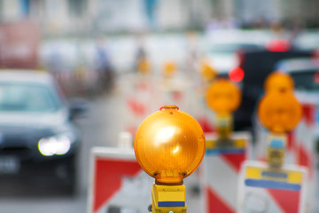 Warning lights at a road construction site in a big city