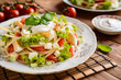 Spaghetti pasta salad with tomato, lettuce, egg, Feta cheese, green onion and sour cream