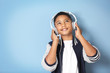 © Africa Studio - African American boy with headphones listening music on blue background