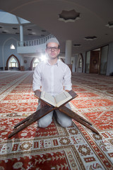 Wall Mural - Religious muslim man praying inside the mosque