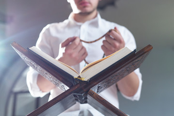 Wall Mural - Young Muslim Man Reading The Koran