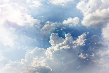 romantic blue dreamy puffy clouds sky with lense flare
