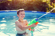 © sakkmesterke - Happy little boy laugh and shoot with squirt gun