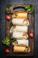 Variety  Of Vegetarian Tasty Wraps On Rustic Cutting Board On Dark Background, Top View. Healthy Lunch Snack