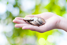 Coins In Hands On Green Nature Background,Donation Investment Fund Financial Support Charity  Dividend Market Growth