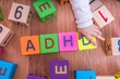 © vchalup - ADHD concept. Baby is playing with cubes with letters.