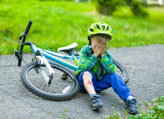 boy fell from the bike in a park