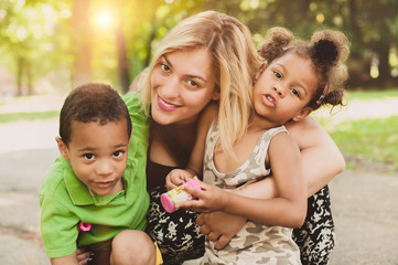 Mother, son and daughter having fun and enjoying in the park