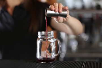 Wall Mural - Woman hands making cocktail on bar counter