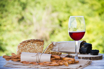 Wall Mural - Wine, bread and wheat on the wooden table