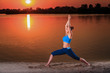 © nazarovsergey - yoga at sunset on the beach.
