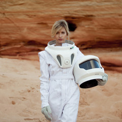 Wall Mural - futuristic astronaut without a helmet on another planet, image with the effect of toning