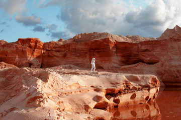 Wall Mural - futuristic astronaut on another planet, image with the effect of toning