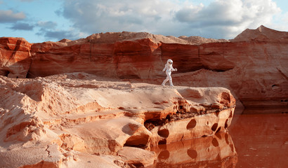 Wall Mural - futuristic astronaut on another planet, image with the effect of toning