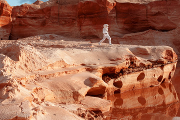 Wall Mural - futuristic astronaut on another planet, image with the effect of toning