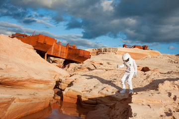 Wall Mural - futuristic astronaut on another planet, Mars. image with the effect of toning