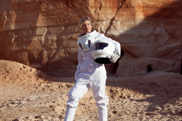 Wall Mural - futuristic astronaut without a helmet on another planet, image with the effect of toning