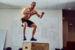 © baranq - Box jump exercise - young man doing functional workout at the gy