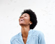 © mimagephotos - Young black woman looking away and laughing