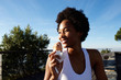 © mimagephotos - Active woman enjoying eating ice cream at the beach