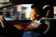 © mimagephotos - Happy young african woman driving a car